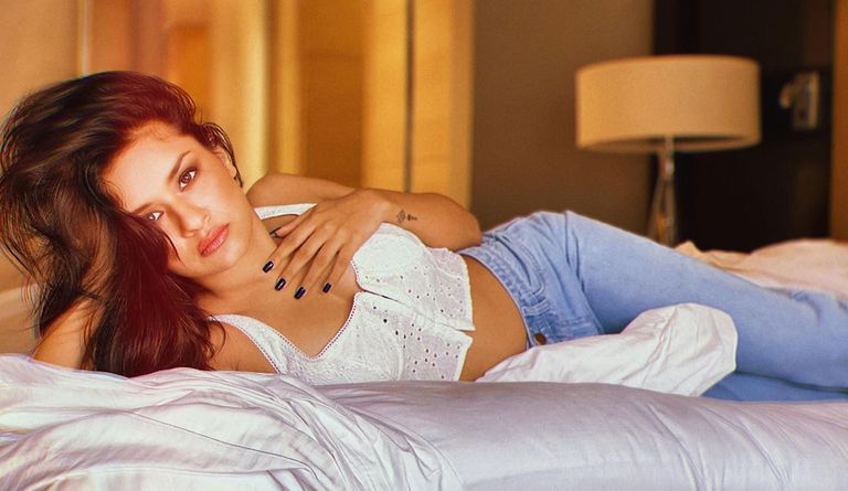 vneet Kaur keeps it hot in the white crop top and denim and was seen laying on the bed.